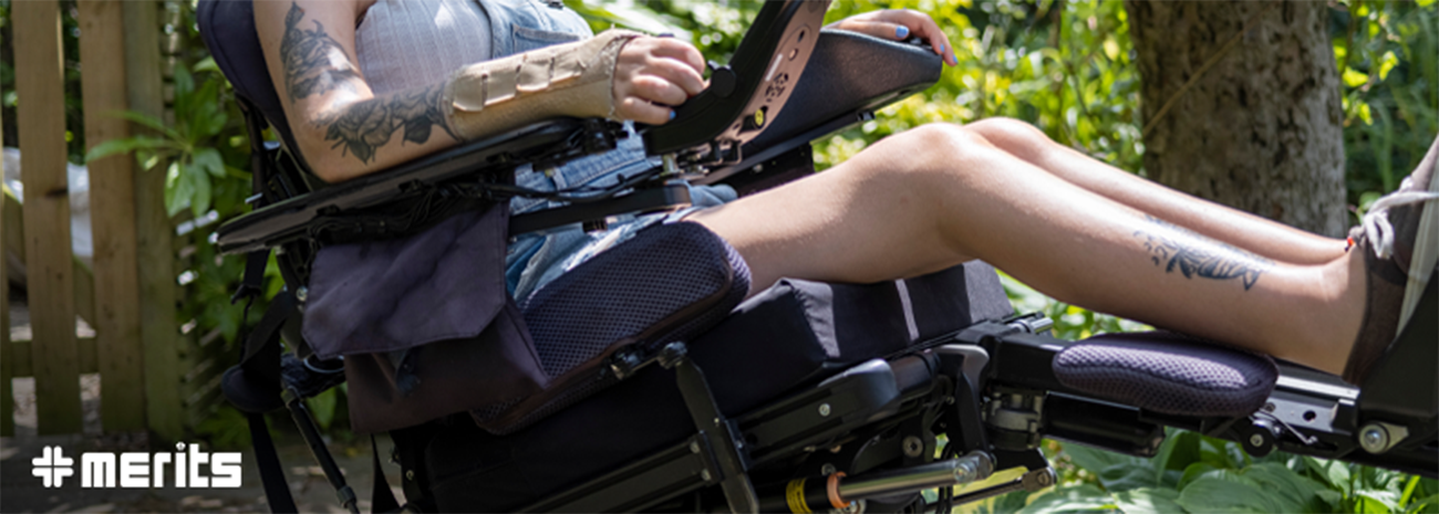 Woman using power wheelchair while in reclined position